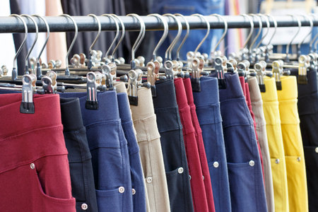 Multicolored casual pants hanging on a hanger close up, side view