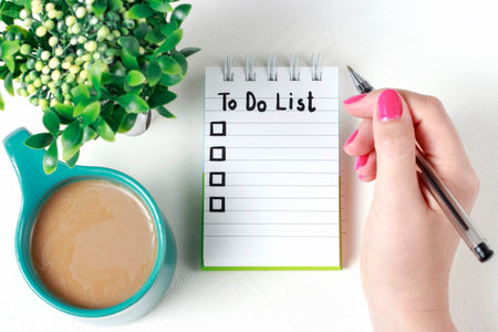 Female hand writes To Do List in notebook, a copy space, planning concept