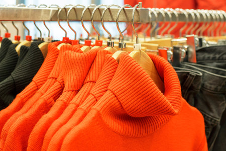 Clothes hanging on hangers in the store, a choice of clothing concept