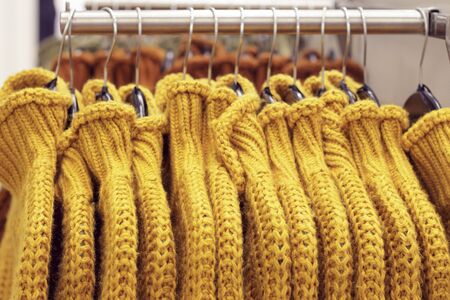 Clothes hanging on hangers in the store, a choice of clothing conceptの写真素材