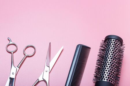 Hairdressing scissors and combs on a pink background, a copy of the space, the concept of a beauty salonの写真素材