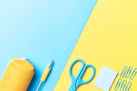 Stationery on a blue and yellow background, a copy space