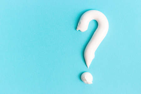 Question mark made from toothpaste on a blue background with copy space.の写真素材