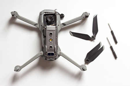 Quad copter, propeller and screwdrivers on a white background, concept of drone repair.