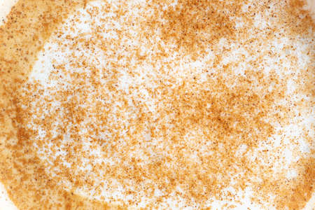 Foam of coffee with a cinnamon close up, top viewの写真素材