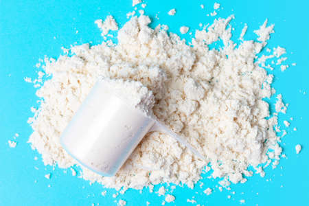 Scattered protein in scoop on blue background top viewの写真素材