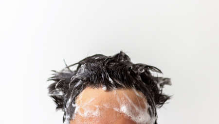 Male head with foam on hair close up on white background, copy space.の写真素材