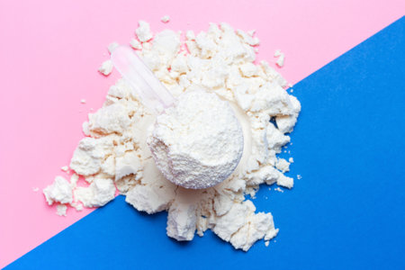 Scattered protein and scoop on blue and pink background.の写真素材