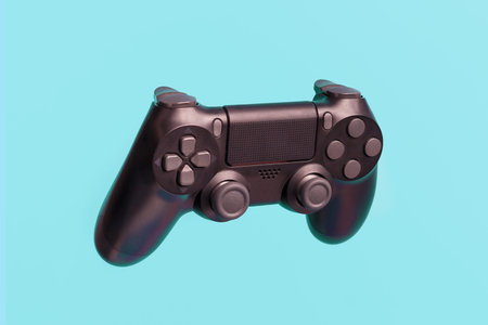 A black joystick for video games on blue background close-up.