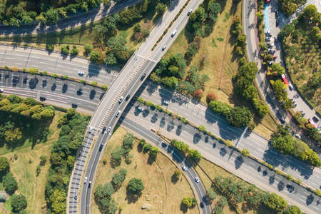 Cars drive along the road junction outside city top view.の写真素材