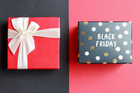 Gift box with Black Friday inscription on red background.の写真素材
