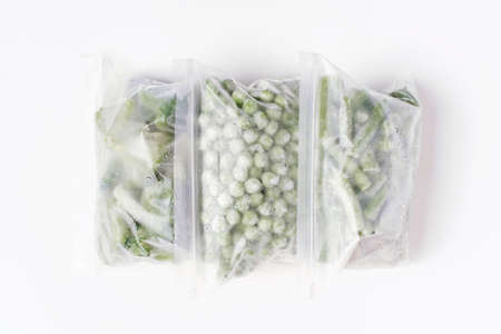 Packages with frozen vegetables inside on white background top view.の写真素材