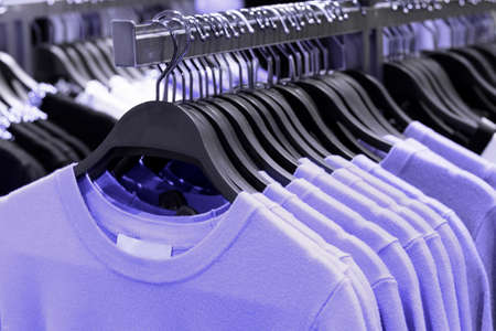 A sweaters trendy purple 2022 on a hanger in store close-up.の写真素材