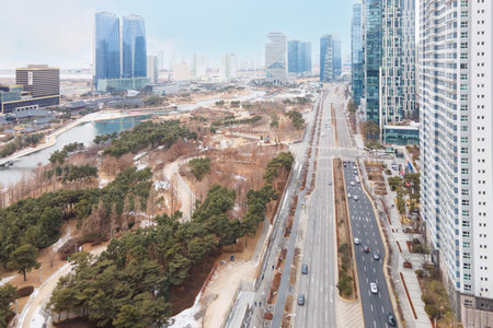 Songdo, South Korea - 02.10.2021: urban central park with river and skyscrapers.