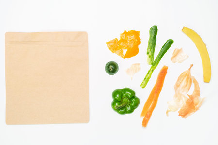 Food leftovers and cardboard bag on white background close-up top view.の写真素材