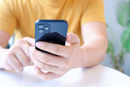 Seoul - 05.04.2022: Male hand holds an iPhone 12 close-up.のeditorial素材