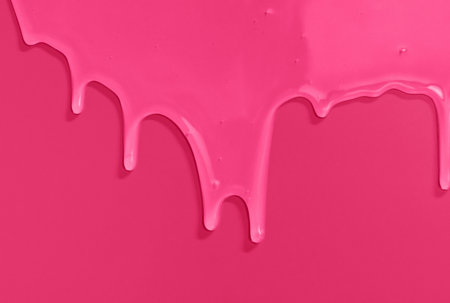 liquid shampoo dripping down on trend color of 2023 Viva Magenta.の写真素材