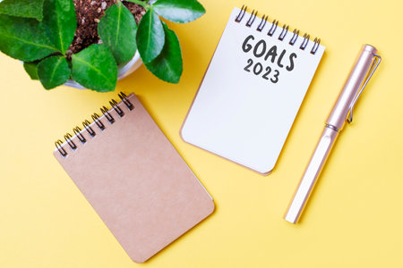 The inscription goals 2023 on notepad on yellow background, top view.の写真素材