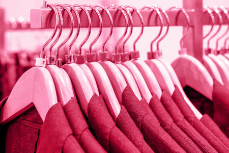 Jackets on hangers in the store, concept of color year 2023 Viva Magenta.の写真素材