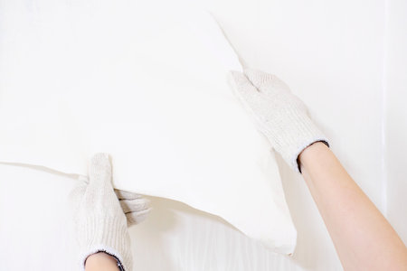 Hands rips off white wallpaper from wall, renovation concept.の写真素材