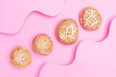Shiitake mushrooms on pink background close-up top view.の写真素材