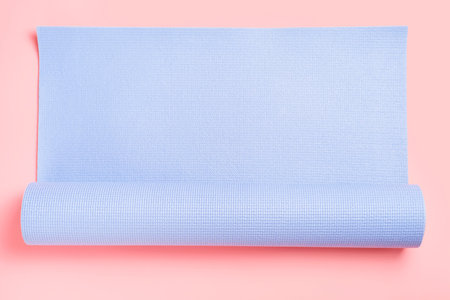 Sports mat for training on a pink background close-up.の写真素材