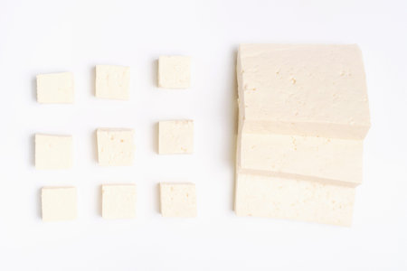 Tofu cut into pieces on a white background close-up top view.の写真素材