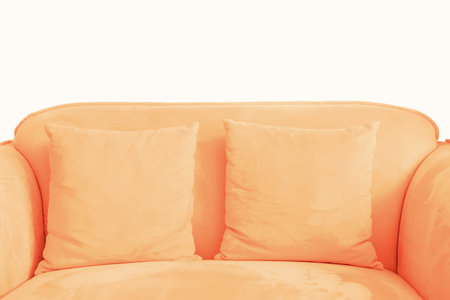 Sofa with pillow against a white wall trending color of the year 2024.
