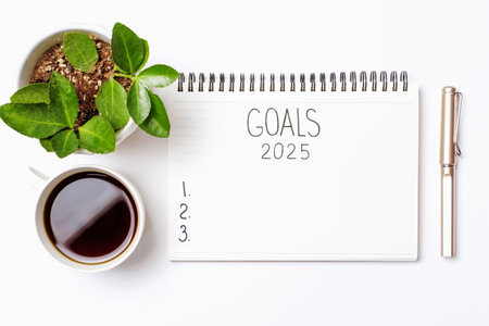 The inscription goals 2025 on notepad on a white background, top view.の写真素材