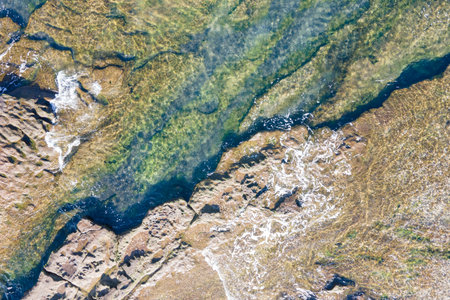 Sea and rocks close-up aerial view, natural background.