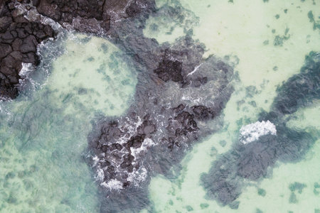 Sea and volcanic rocks close up aerial view, natural background.の写真素材