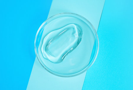 Smear of moisturizing face gel on blue background close-up.の写真素材