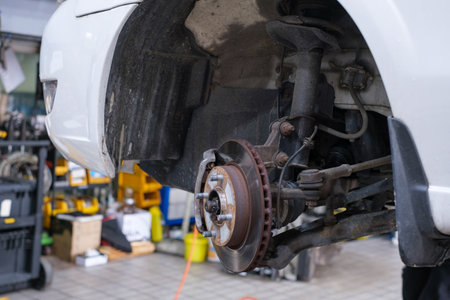 Repair of old brake pad in car service close-up.の写真素材