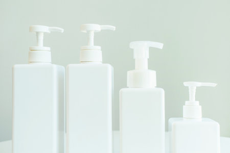 White plastic bottles with detergents on a gray background side view.の写真素材