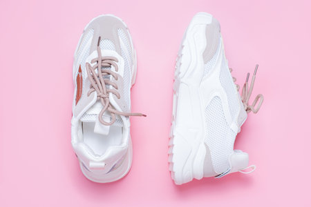 Pair of stylish sneakers on pink background close up.の写真素材