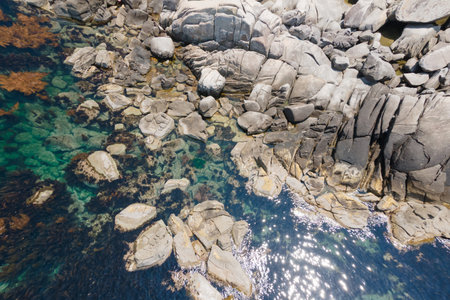 A turquoise ocean water and rocks aerial view, natural background.の写真素材
