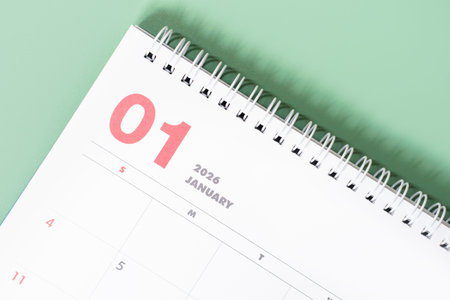 January 2026 calendar close-up on green background, planning concept.
