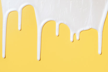 liquid moisturizing shampoo dripping down on yellow background close-up.の写真素材
