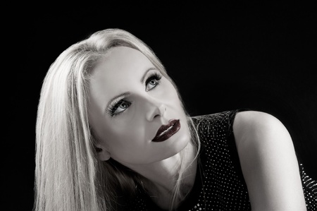 Black and white portrait of a beautiful blonde woman isolated on black backgroundの写真素材