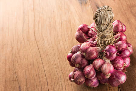 closeup shallot onion group on wood backgroundの写真素材