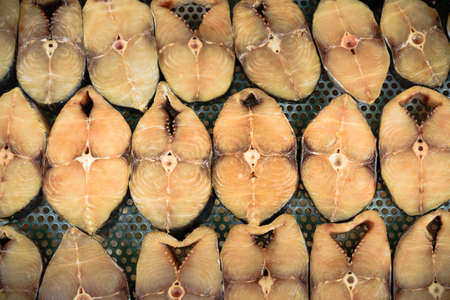 dried fish array on panel in market top view.の写真素材
