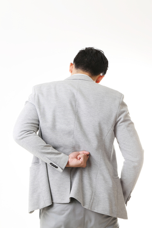 Portrait of Asian Man with back pain in Isolated Backgroundの写真素材