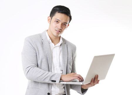 Portrait of Asian Man with a laptop in Isolated Backgroundの写真素材