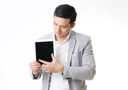 Portrait of Asian Man with a tablet in Isolated Backgroundの写真素材