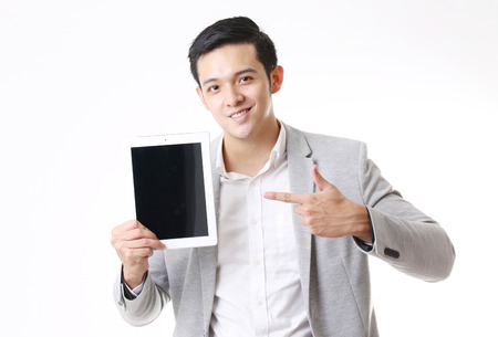Portrait of Asian Man with a tablet in Isolated Backgroundの写真素材