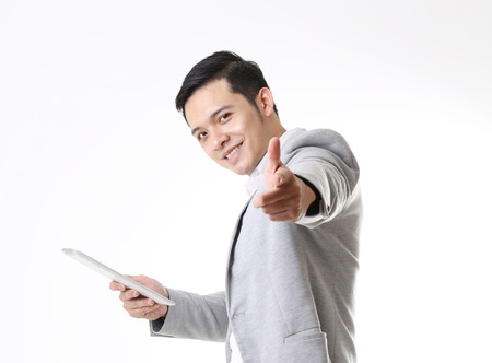 Portrait of Asian Man with a tablet in Isolated Backgroundの写真素材