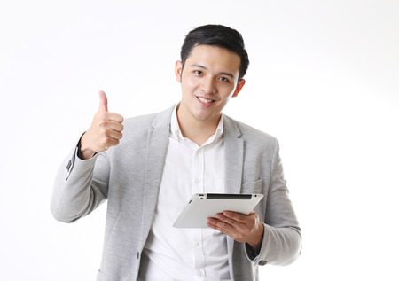 Portrait of Asian Man with a tablet in Isolated Backgroundの写真素材