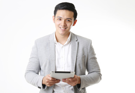 Portrait of Asian Man with a tablet in Isolated Backgroundの写真素材