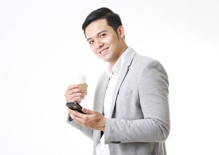Portrait of Asian Man with a phone in Isolated Backgroundの写真素材