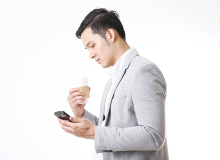 Portrait of Asian Man with a phone in Isolated Backgroundの写真素材